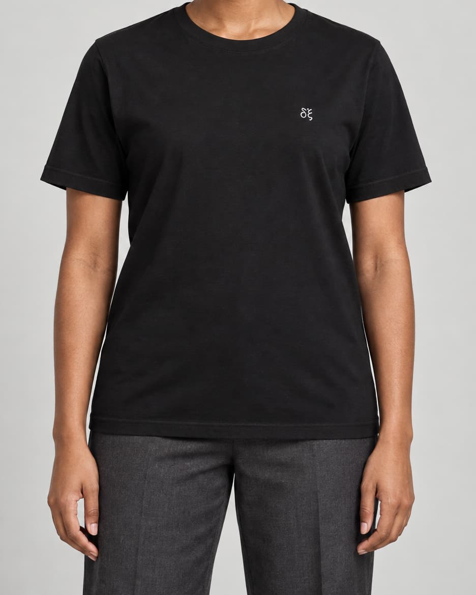 Black Embroidered DX T-shirt on an adult model in a neutral studio, front view